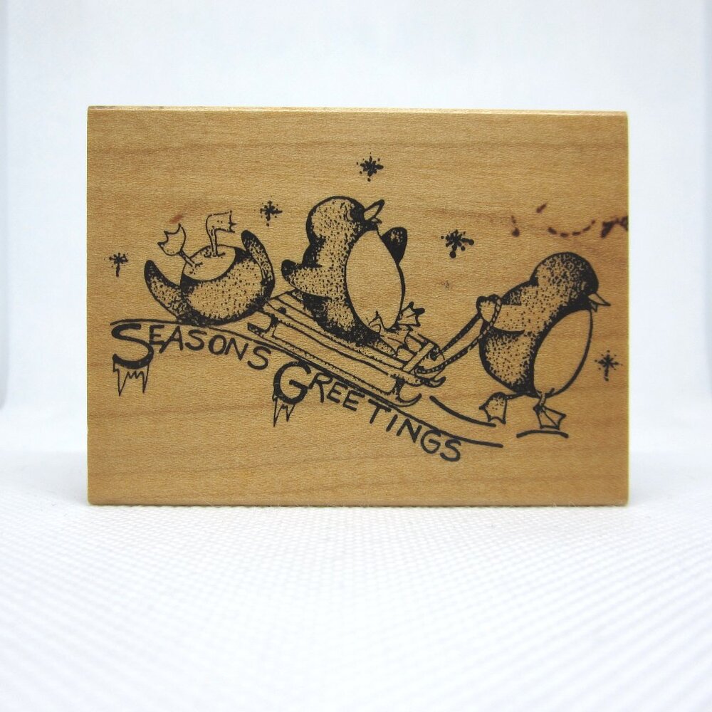Embossing Arts Seasons Greetings with sledding penguins rubber stamp
